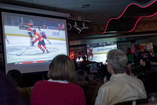 People gathered watching hockey 
