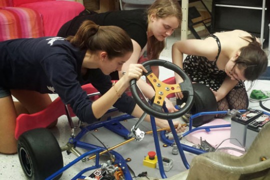 People working on go kart