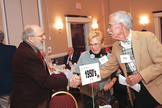 People shaking hands at event