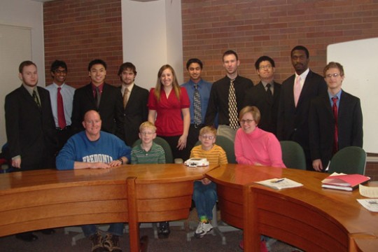 People gathered around desk
