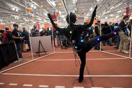 Person in black wearing colored orbs at imagine rit.