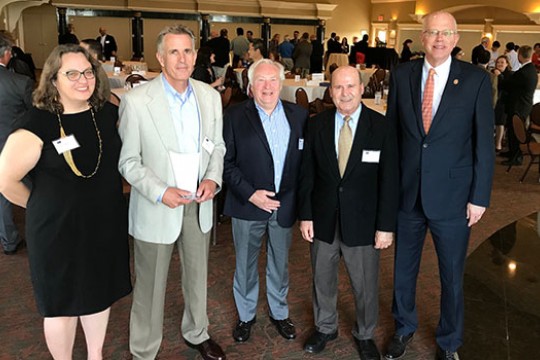 Bruce Smith poses for a photo with four other people at the Inventor of the Year award ceremony.