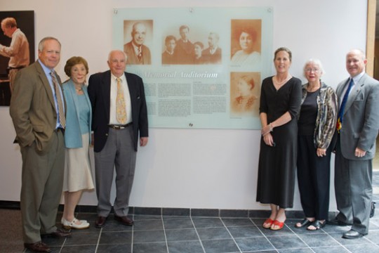 People posing around display