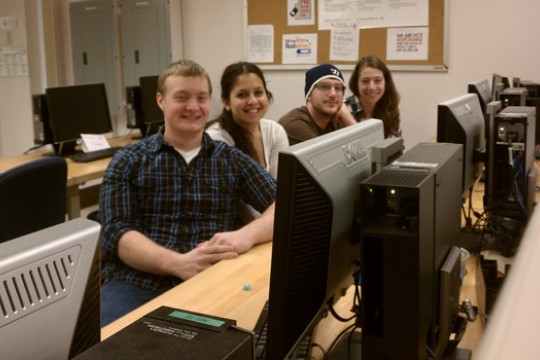 People posing in computer lab