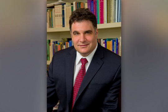 People posing in front of books