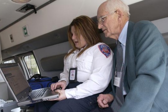 Emergency worker showing someone a program