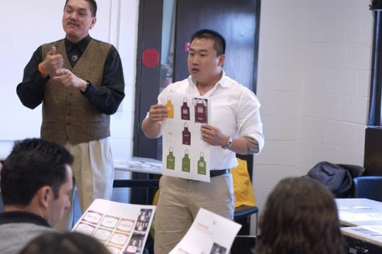 Two people displaying different products to an audience