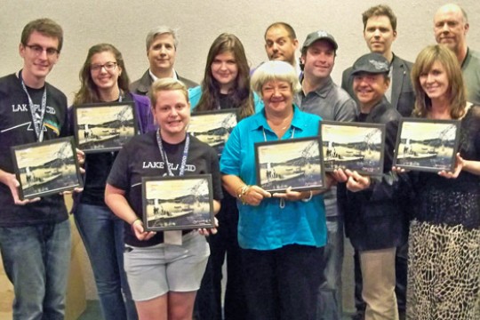 People gathered for picture with paintings