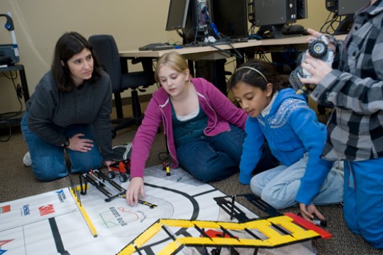 People working on robots in classroom
