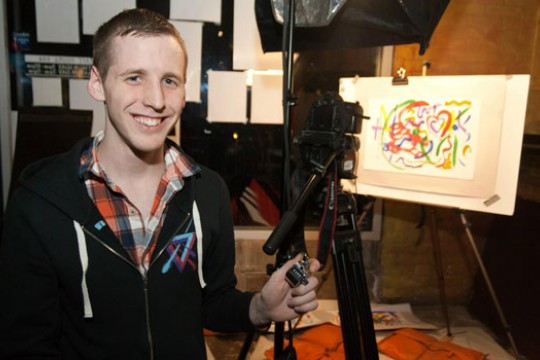 Person taking pictures of art display