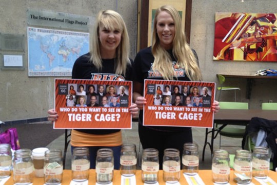 Two people posing at table 