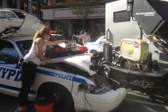 Person working on police car in front of camera