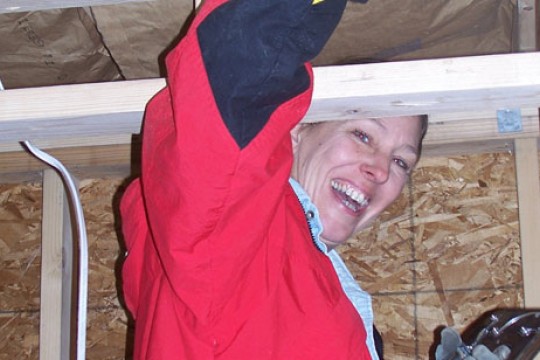 Staff Assistant nailing in boards to a wall