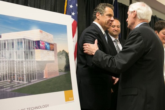 People talking on stage next display