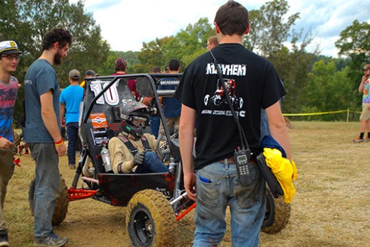 People gathered around BAJA vehicle