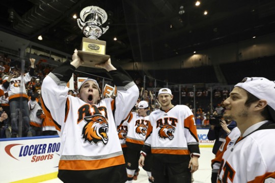 Hockey players holding award