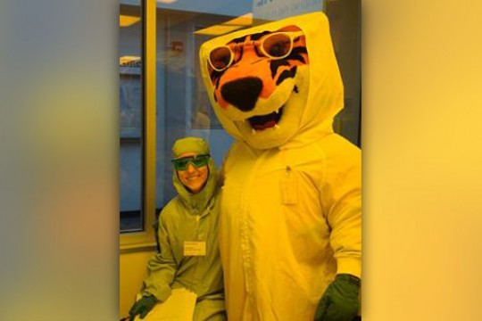 Mascot and person in lab