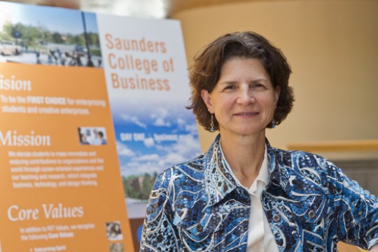 Dean standing in front of poster.