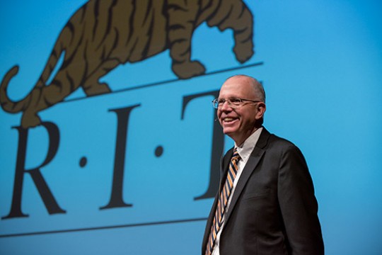 Picture of President Munson next to RIT logo