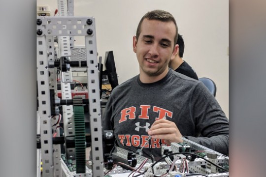 Shane Murphy works on a robot.