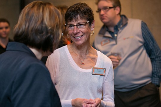 Nancy Munson talking to people at event