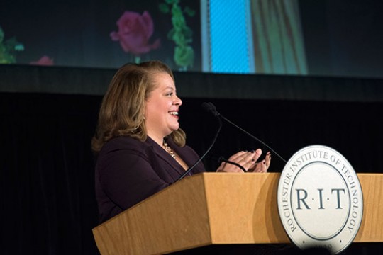 Norma Holland giving speech at podium