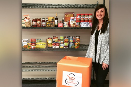 Person posing by shelfs with food