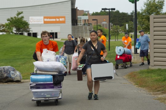 People walking down path with bags