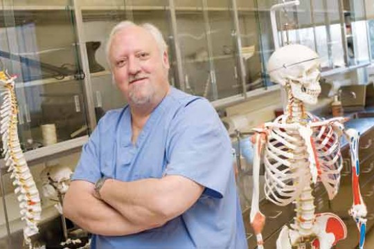 Professor posing for camera in lab
