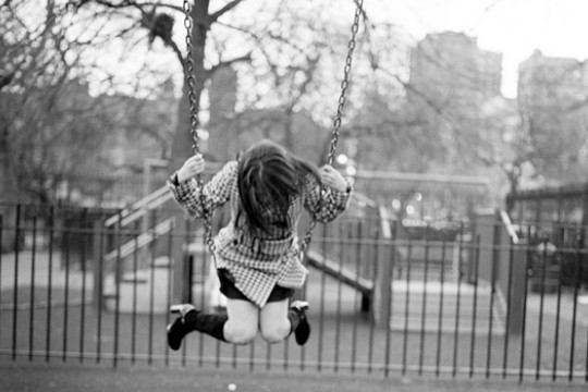 Photo of someone swinging on swing set