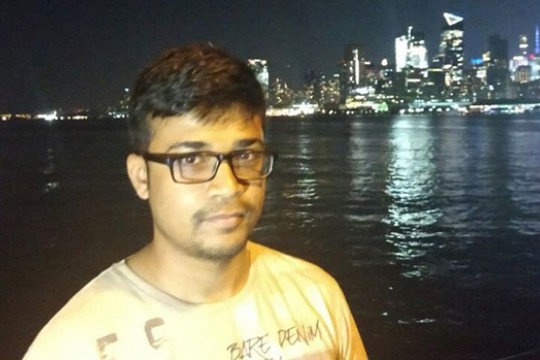 Pratik Shirish Kulkarni in front of a city skyline.