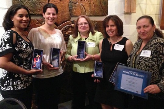 People posing with awards