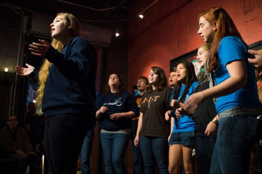 People singing together on stage