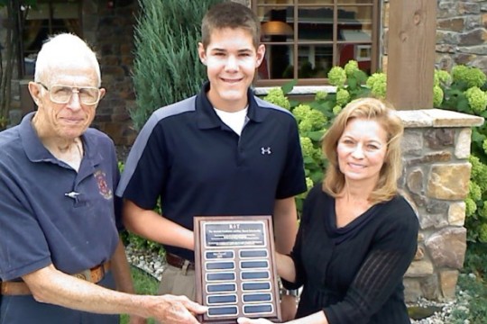 People posing with award