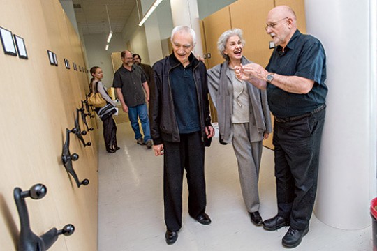 People gathered at event looking at display