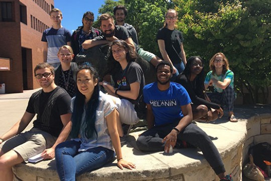 Group of students gather for a picture on campus.