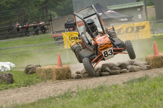 Person driving vehicle down dirt path
