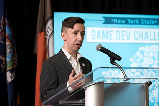 Rob Mostyn talking behind a podium.