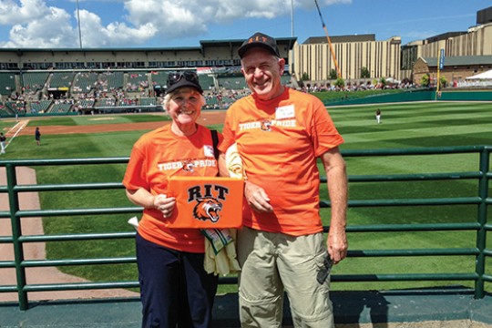 Two people posing at baseball game