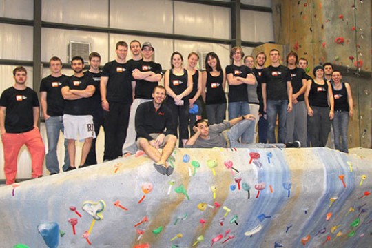 People posing on top of rock wall