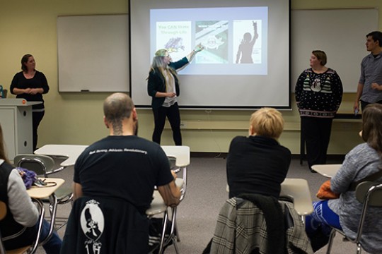 Professor teaching classroom to group of people