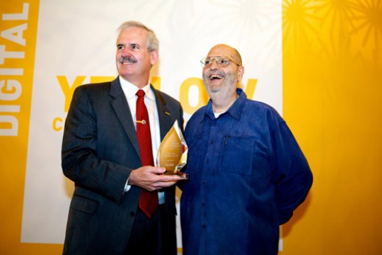 People posing at event with award