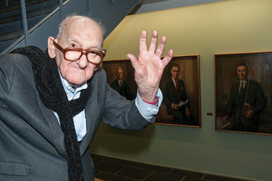 Person posing by portraits