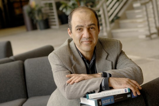 Person posing for camera with textbooks
