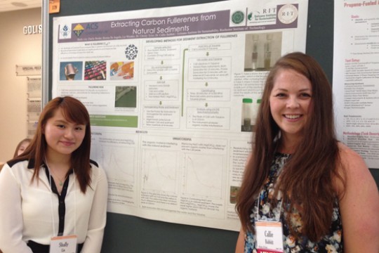 Two people standing near poster