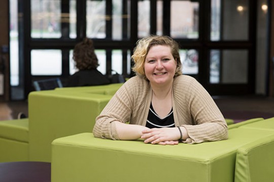 Portrait of Elizabeth Sheffield on a green couch.