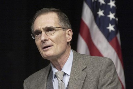 RIT President presenting in front of the United States of America Flag