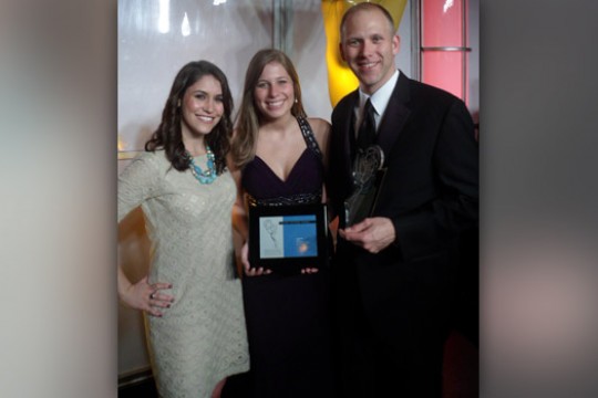 People posing with award