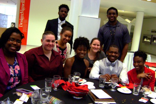 People posing around table 