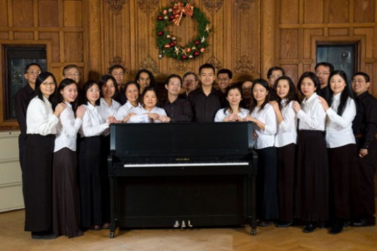 People gathered around piano